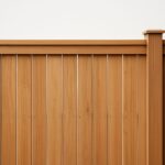 Close-up of a wooden fence showing vertical slats and a top rail